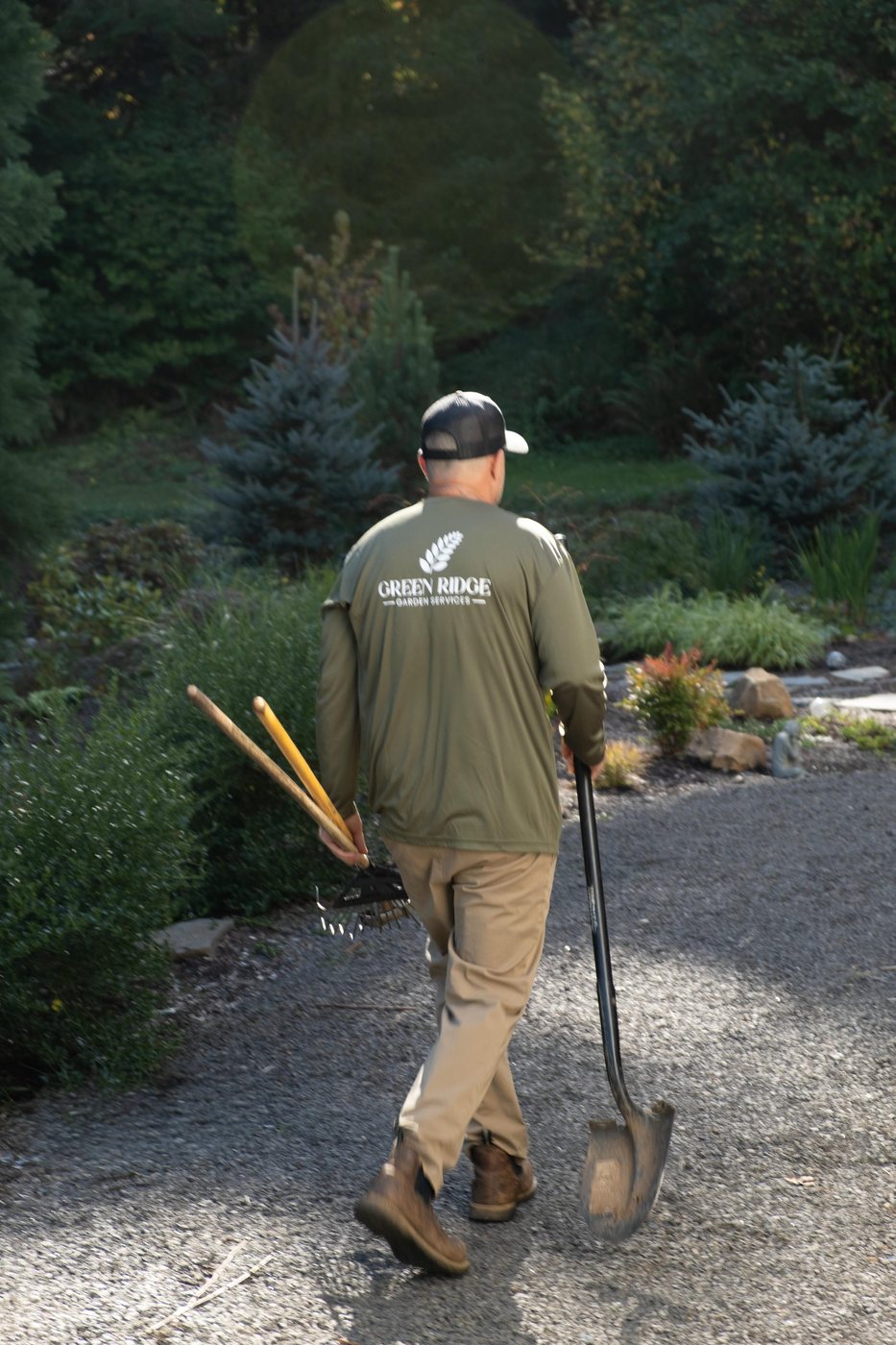 Adam Todd of Green Ridge Garden Services walking a job with tools