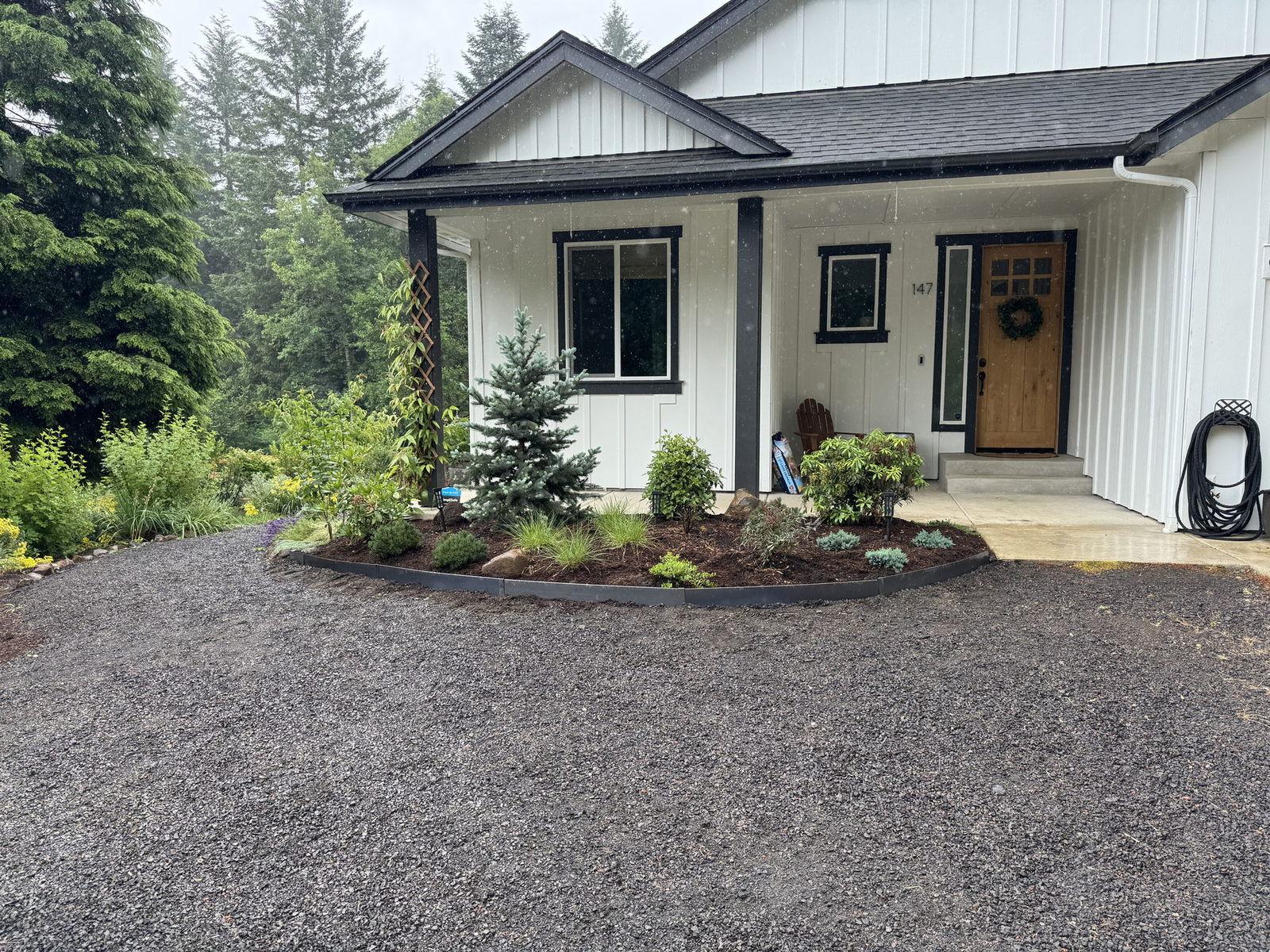 Fresh mulch and plantings along a modern farmhouse porch